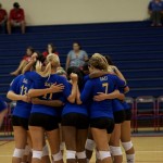 a photo of the volleyball team in a huddle in Hawaii