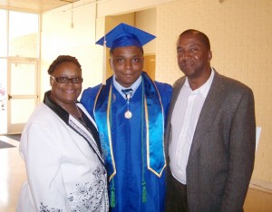 Cameron Sumlin poses for a graduation photo with his parents, Sabrina and Jeffery Sumlin.